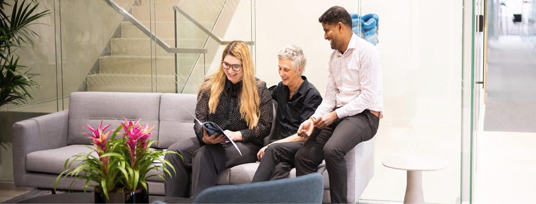 Three employees sitting on couch at Norges Bank Investment Management's London office.