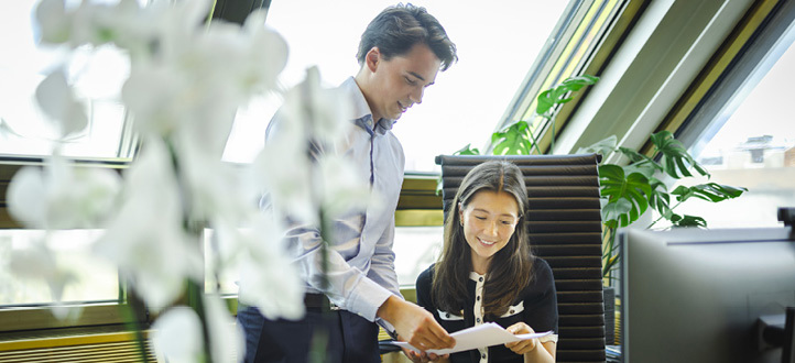 Two colleagues reviewing a document together at the Oslo office.