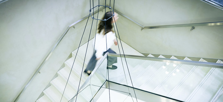 A woman is walking down a staircase in a building.

AI generated content