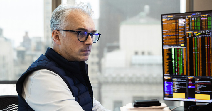 Employee working at a trading desk in the New York office.