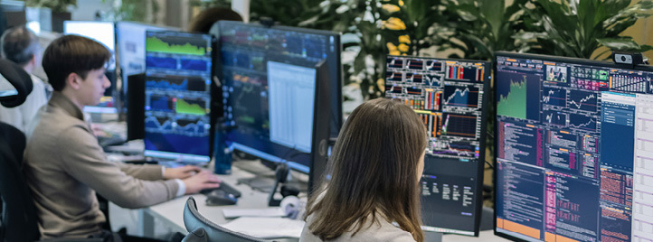 Two people are working at a desk with multiple computer screens.

AI generated content
