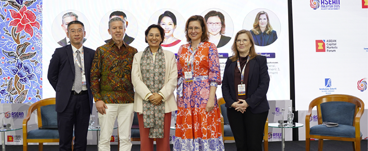 Person working at multiple computer monitors displaying financial market data and charts.