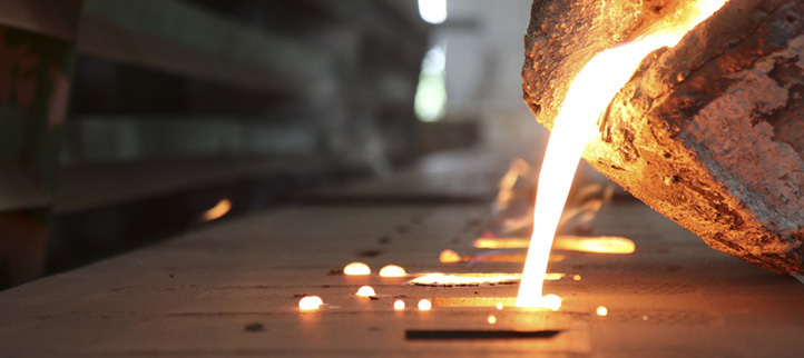Molten metal being poured in an industrial setting.